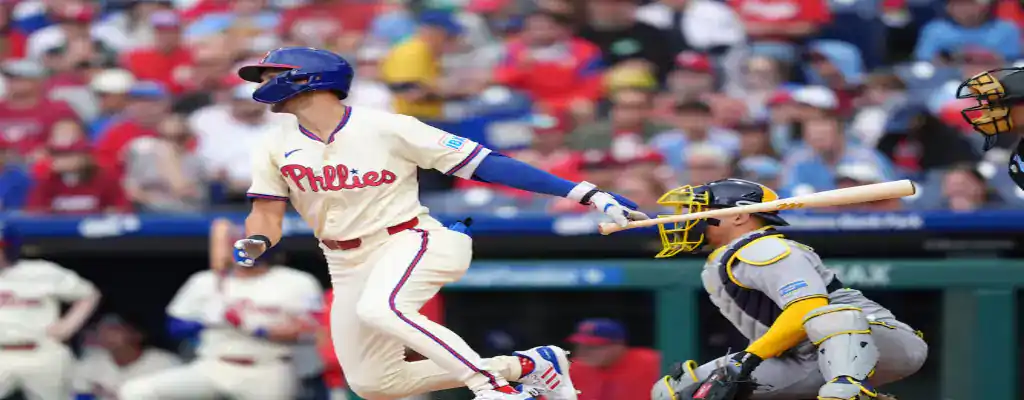 Toronto Blue Jays vs Philadelphia Phillies Picks and Predictions June 5th 2025 2 Philadelphia Phillies player follows through on a swing during a game, with the catcher and umpire watching behind him.