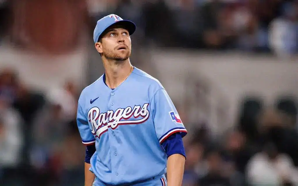 Pittsburgh Pirates vs Texas Rangers Picks and Predictions June 20th 2025 2 A Texas Rangers player in a light blue jersey stands on the field, focused during a game with fans blurred in the background.
