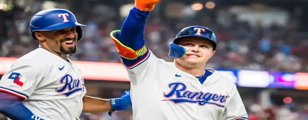 Washington Nationals vs Texas Rangers Picks and Predictions June 7th 2025 2 Texas Rangers players celebrate a home run, smiling and gesturing with excitement in front of a cheering crowd.