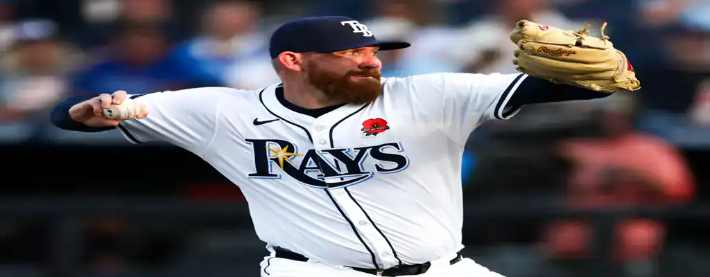 Tampa Bay Rays vs Miami Marlins Picks and Predictions June 7th 2025 3 Tampa Bay Rays pitcher captured mid-throw in a close-up, wearing a white uniform and navy cap with glove raised.