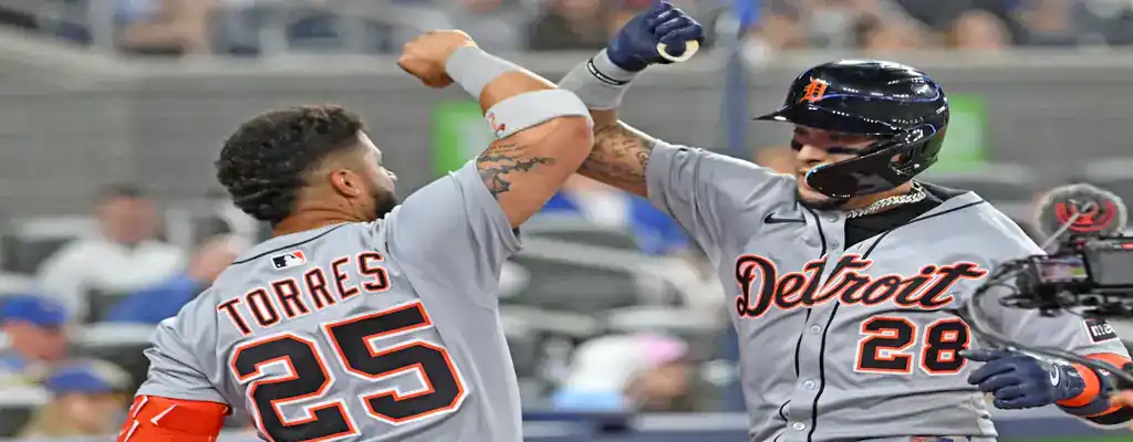 Chicago White Sox vs Detroit Tigers Picks and Predictions June 5th 2025 2 Detroit Tigers players celebrate after a scoring play with a forearm bash, wearing gray road uniforms and helmets.