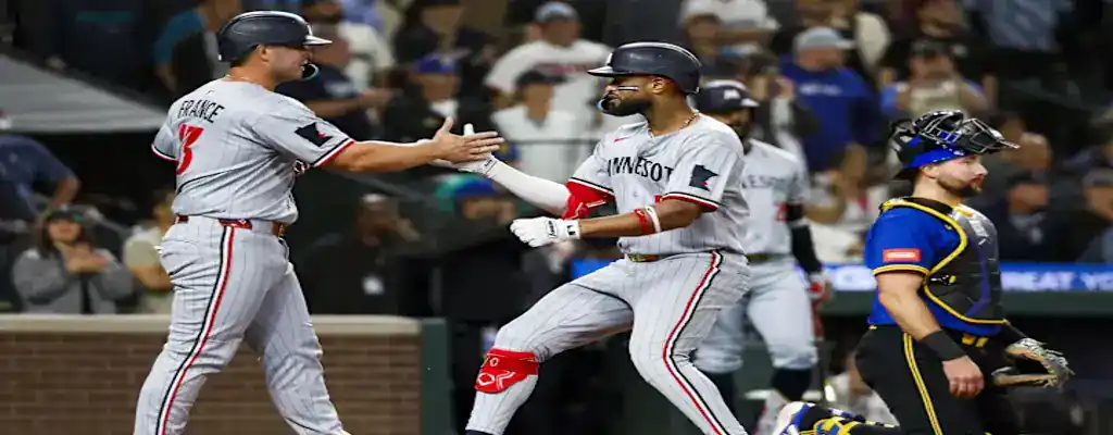 Oakland Athletics vs Minnesota Twins Picks and Predictions June 4th 2025 2 Minnesota Twins players celebrate at home plate after a home run, exchanging a handshake in gray alternate uniforms.