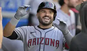 Arizona Diamondbacks player smiling and celebrating in the dugout during a game against the Houston Astros