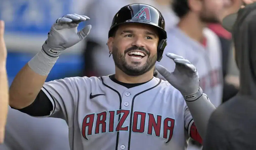 Arizona Diamondbacks player smiling and celebrating in the dugout during a game against the Houston Astros