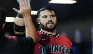 Arizona Diamondbacks player celebrates with teammate during game against the Kansas City Royals.