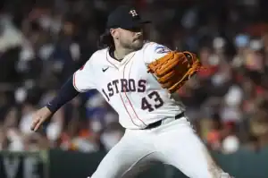 The image features a baseball player in the midst of throwing a baseball. He is wearing a sports uniform and is likely positioned on a baseball field
