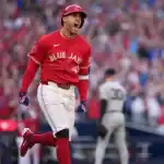 Toronto Blue Jays baseball player running around the base after batting.