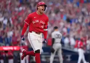 Toronto Blue Jays baseball player running around the base after batting.