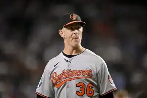 The image features a man dressed in a baseball uniform. He is likely participating in or representing the sport of baseball, which is played outdoors.