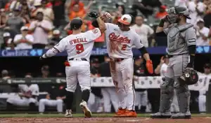 Orioles players celebrate at home plate during game vs Blue Jays on July 28 2025