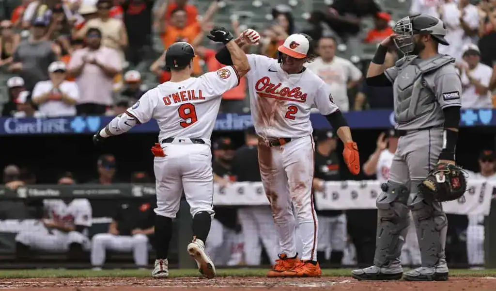 Orioles players celebrate at home plate during game vs Blue Jays on July 28 2025