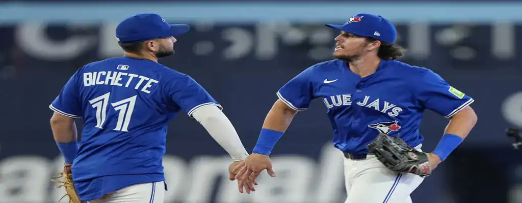Toronto Blue Jays vs Los Angeles Angels Picks and Predictions July 4th 2025 3 Toronto Blue Jays teammates celebrating on the field after a successful play