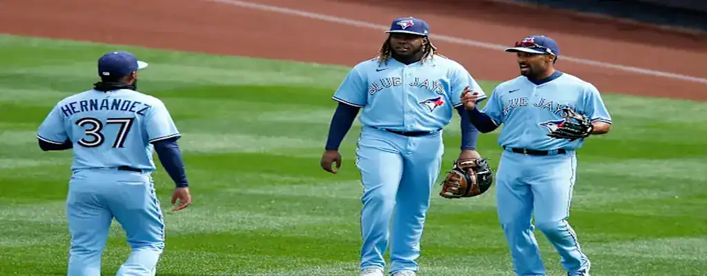 Toronto Blue Jays players sharing a moment of celebration on the field