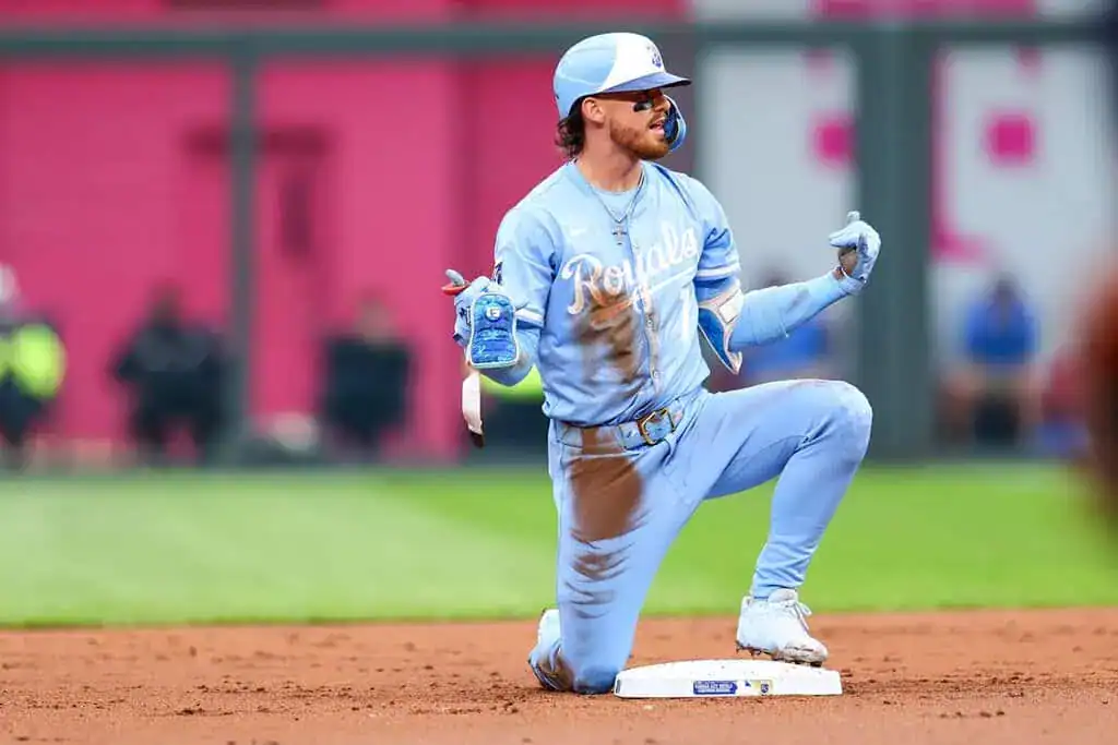 Seattle Mariners vs Kansas City Royals Picks and Predictions July 1st 2025 2 A baseball player in a light blue uniform kneels on the field, celebrating with a water bottle in hand, dirt smudged on his uniform.