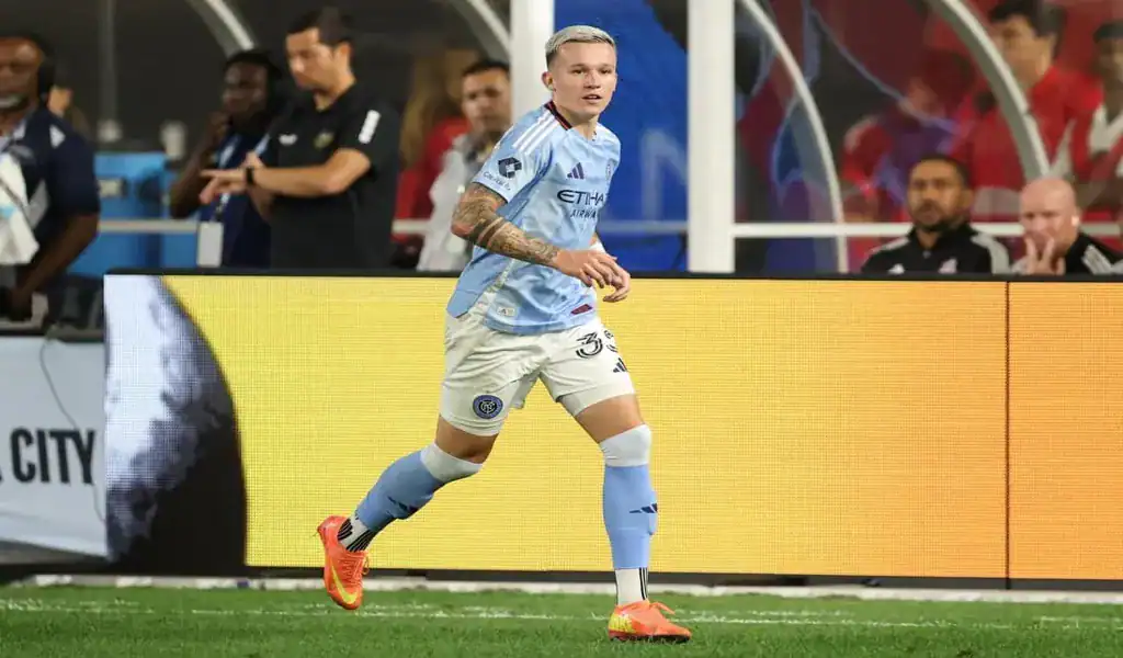 New York City FC player sprinting near the sideline during a match against Charlotte FC