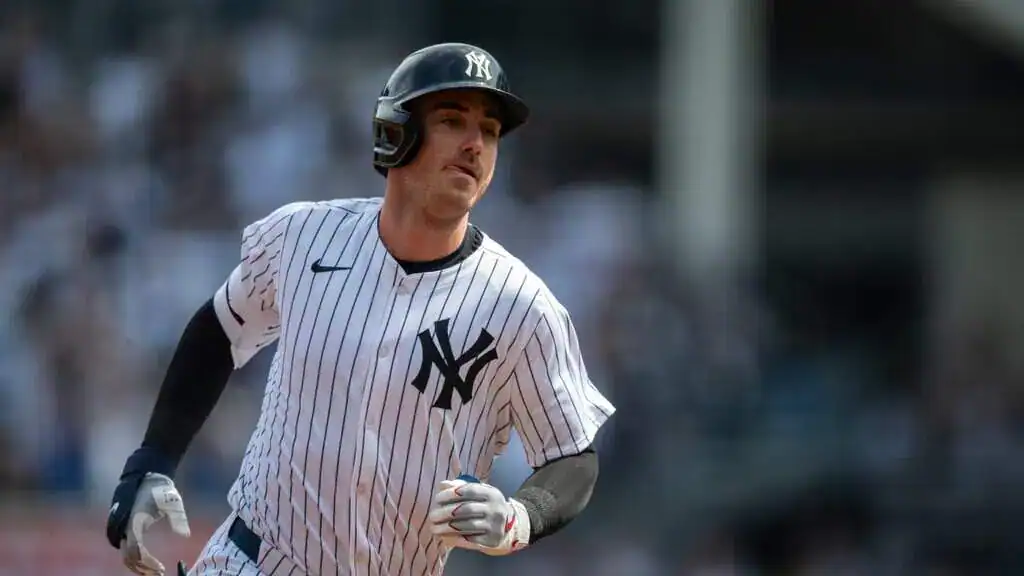 New York Yankees vs Chicago Cubs Picks and Predictions July 12th 2025 2 A New York Yankees baseball player runs on the field, wearing a pinstriped jersey and helmet, with the stadium blurred in the background.