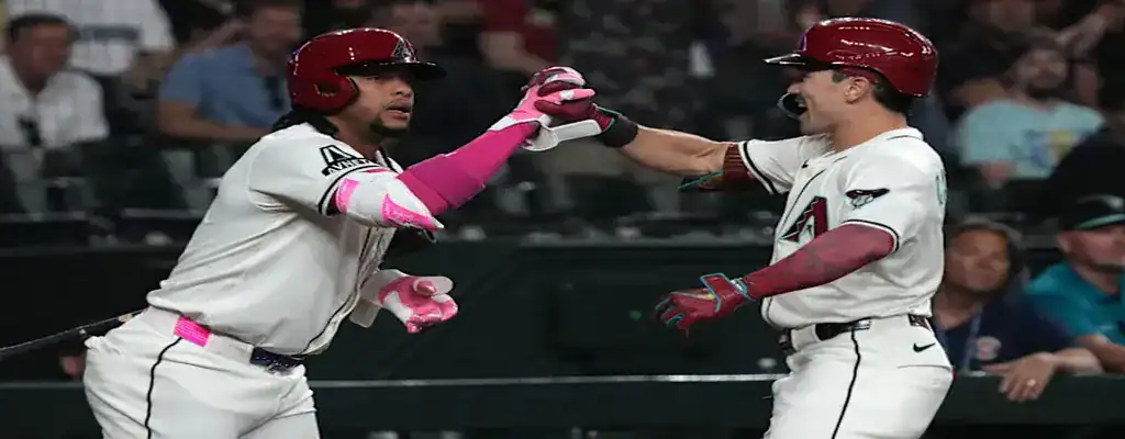 Two Arizona Diamondbacks players celebrating during a baseball game