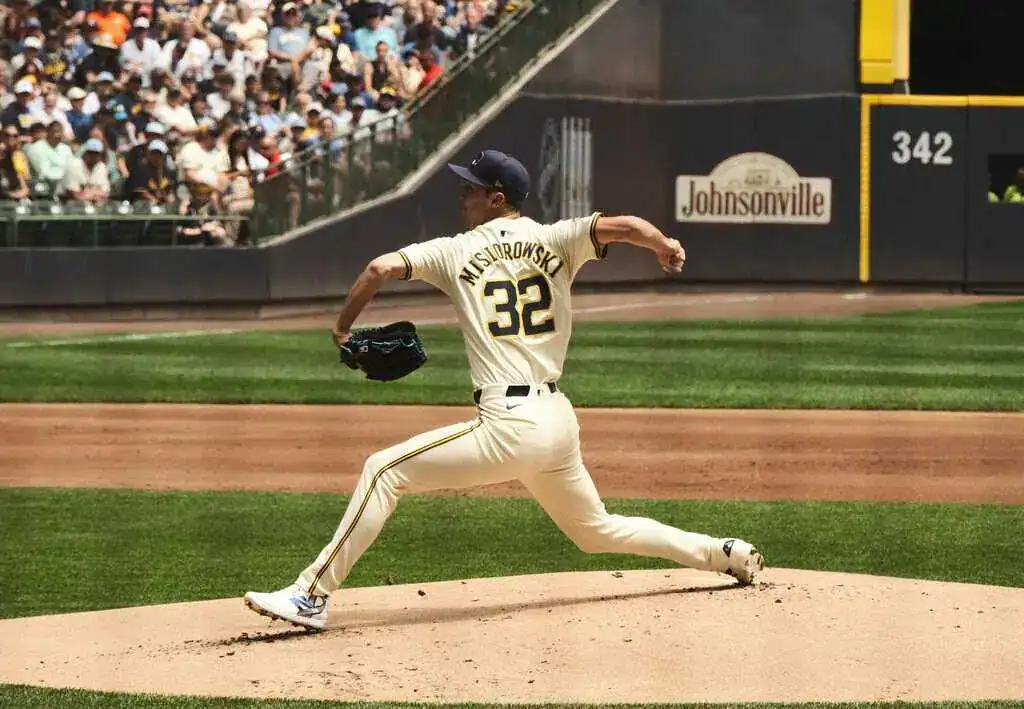 Milwaukee Brewers vs Los Angeles Dodgers Picks and Predictions July 9th 2025 2 A pitcher in a cream jersey with "Mysiorowski" and the number 32 prepares to pitch on a sunny day, with a cheering crowd in the background.