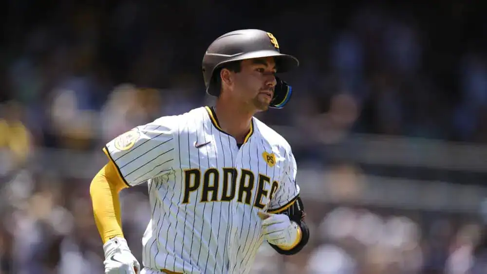 San Diego Padres vs Texas Rangers Picks and Predictions July 6th 2025 2 A baseball player in a white and yellow striped San Diego Padres jersey runs on the field during a sunny day game.