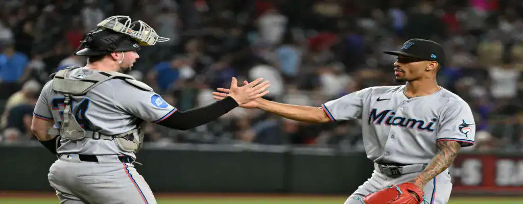 Miami Marlins players celebrating a win on the field