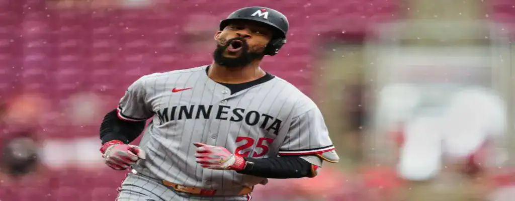 Minnesota baseball player celebrates during a game in the rain
