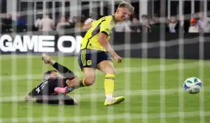 Nashville SC player battling for the ball with Philadelphia Union opponent during MLS game