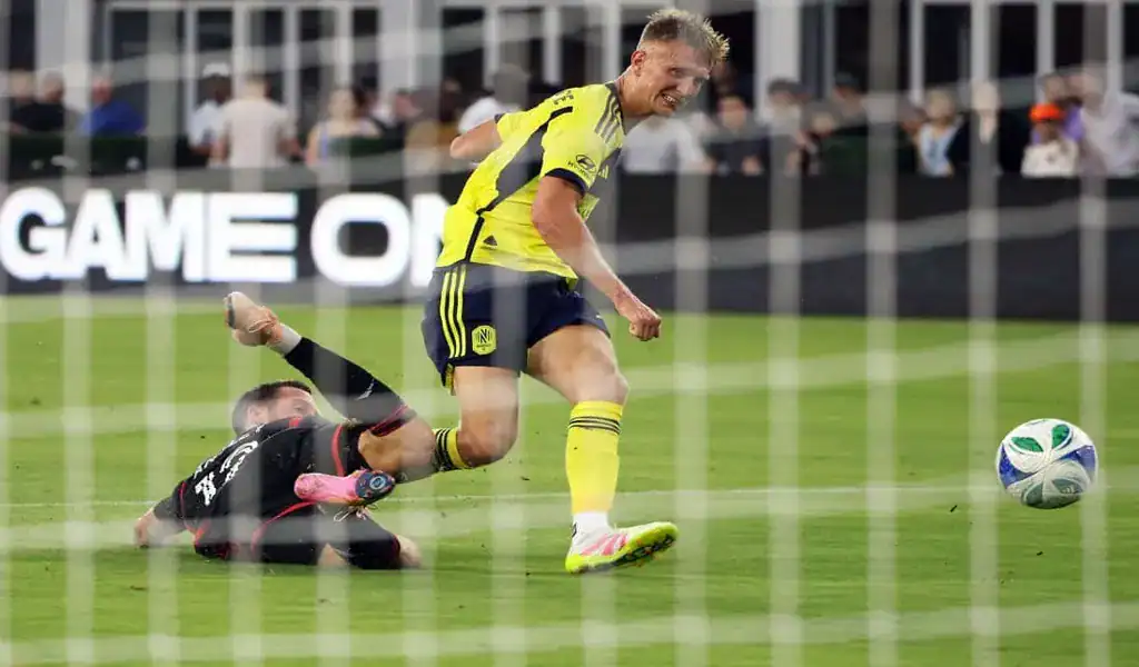 Nashville SC player battling for the ball with Philadelphia Union opponent during MLS game