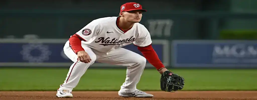 Washington Nationals infielder crouched in a ready stance awaiting the pitch on defense
