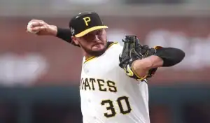 Pittsburgh Pirates pitcher in full motion delivering a pitch during a game against the Detroit Tigers