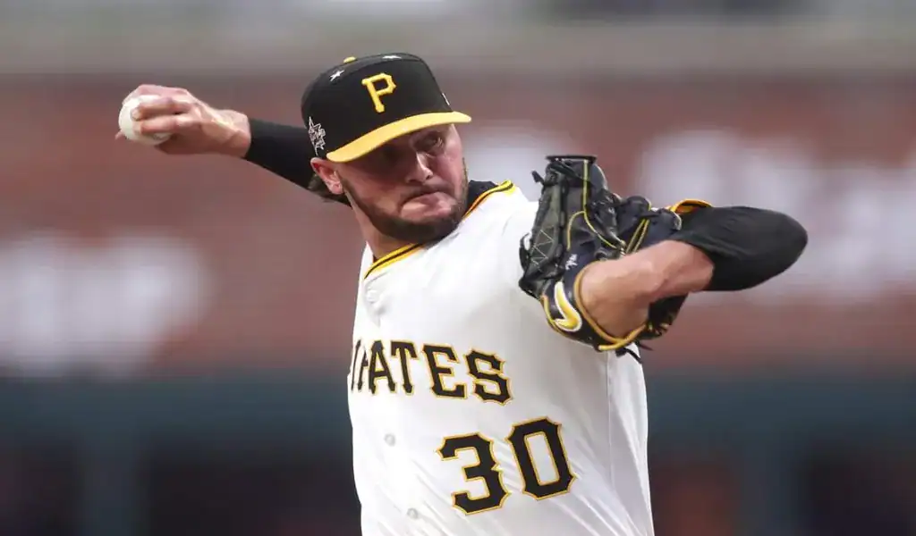 Pittsburgh Pirates pitcher in full motion delivering a pitch during a game against the Detroit Tigers