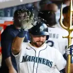 Seattle Mariners player celebrates in dugout with golden trident after play against Kansas City Royals on July 3rd 2025