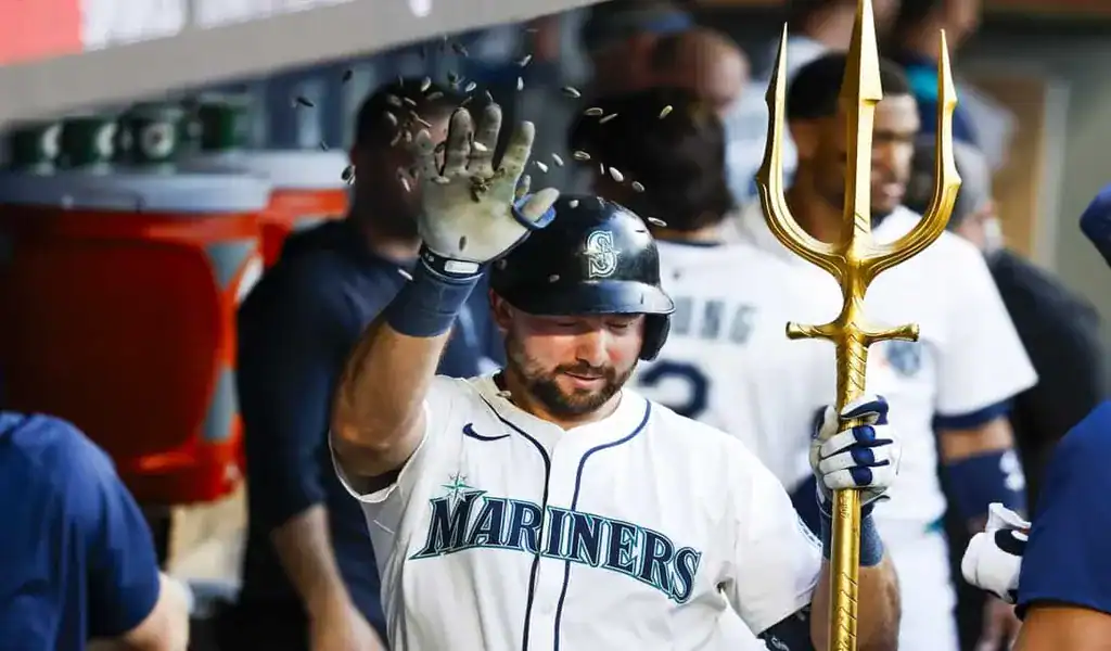 Seattle Mariners player celebrates in dugout with golden trident after play against Kansas City Royals on July 3rd 2025