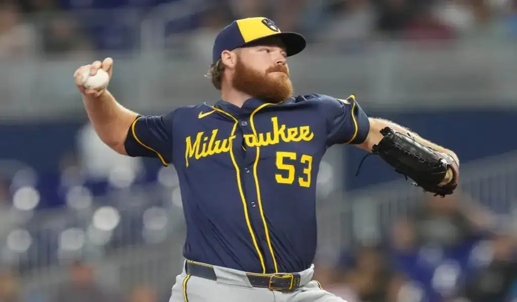 Milwaukee Brewers pitcher in mid-throw during a matchup against the Seattle Mariners