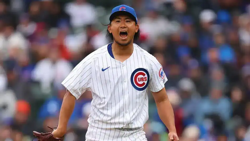 A pitcher in a Chicago Cubs uniform stands on the mound, focused and ready for the next play during a game.