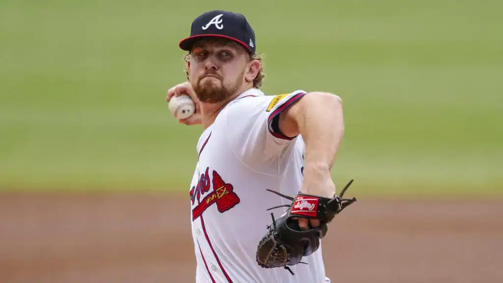 Atlanta Braves vs New York Yankees Picks and Predictions July 18th 2025 2 A baseball player in an Atlanta Braves jersey winds up to pitch, with a focused expression and baseball poised in his throwing hand.