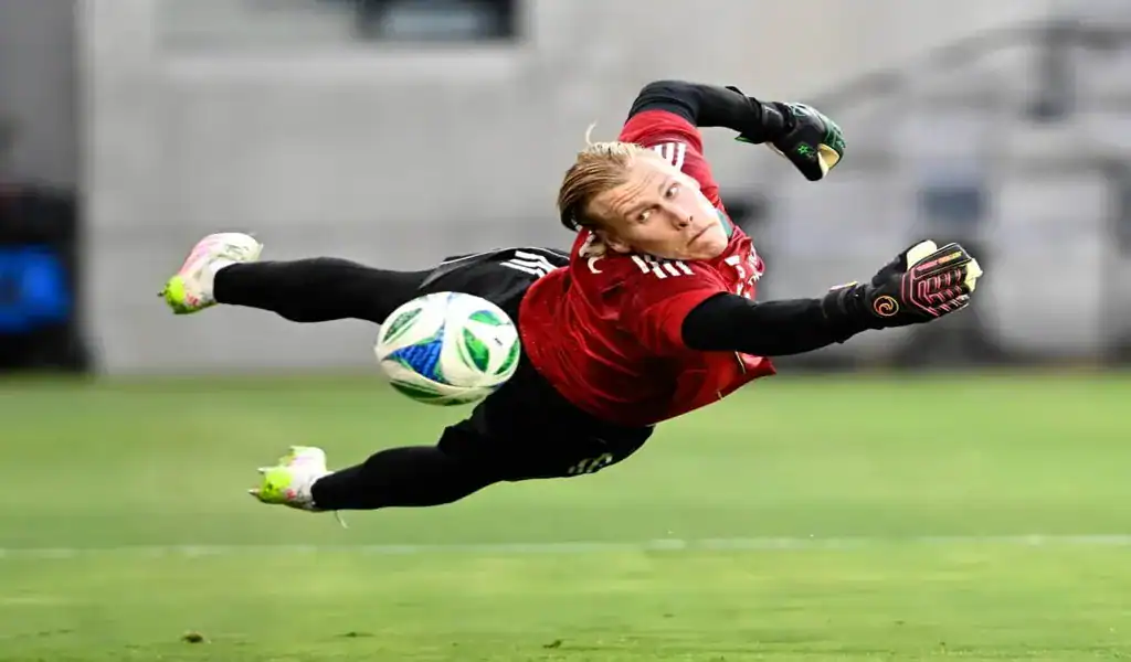 Goalkeeper in mid-air dive during warmups ahead of the Sporting Kansas City vs Seattle Sounders FC match