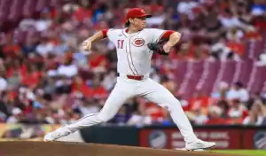 Cincinnati Reds pitcher mid-throw during a game against the Washington Nationals