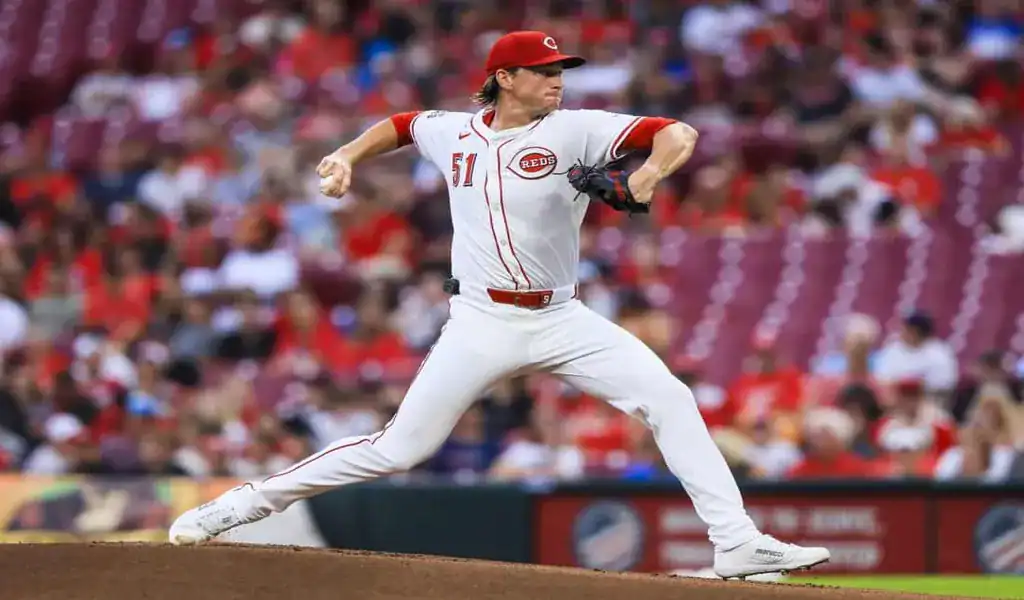 Cincinnati Reds pitcher mid-throw during a game against the Washington Nationals