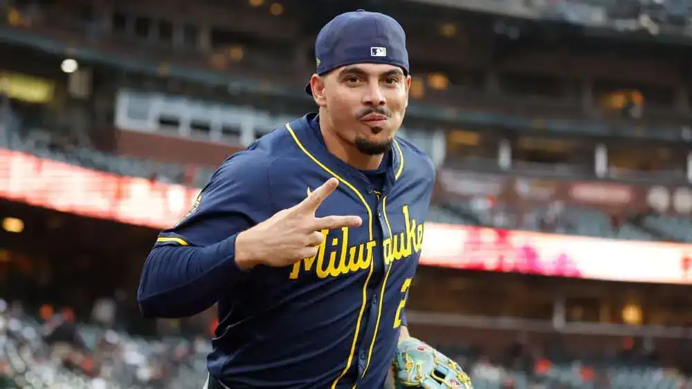 Oakland Athletics vs San Francisco Giants Picks and Predictions July 6th 2025 2 A baseball player in a blue Milwaukee Brewers jersey gestures playfully while running onto the field during a game.
