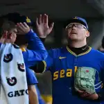 Seattle Mariners players high-fiving in the dugout during game against New York Yankees