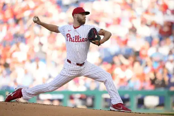 Philadelphia Phillies vs Cincinnati Reds Picks and Predictions July 6th 2025 2 A baseball player wearing a Phillies uniform is captured in the act of throwing a ball.