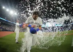 A man is running in a baseball uniform, representing the BLUE JAYS.