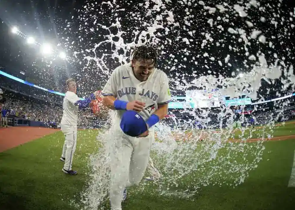 A man is running in a baseball uniform, representing the BLUE JAYS.