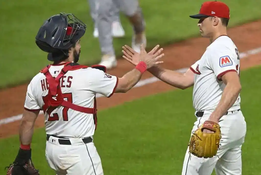 A Cleveland Guardians catcher and pitcher share a high-five after a game.