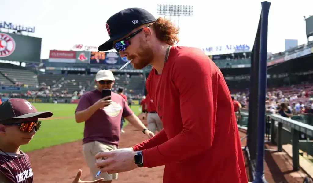 Boston Red Sox player signs autographs before matchup vs Kansas City Royals on August 6, 2025
