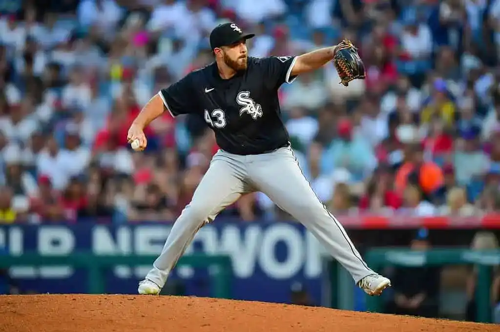 A Chicago White Sox pitcher, wearing number 43, is in the middle of throwing the ball, with the crowd out of focus in the background.