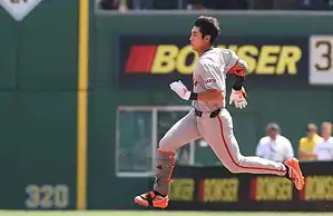 A San Francisco Giants player sprints down the field, showing determination and energy.
