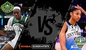 Action shot of two WNBA players from the Seattle Storm and Chicago Sky in an exciting match, highlighting the competitive nature of the game.