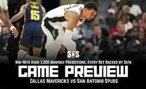 An NBA player crouches on the court during a game preview for the Dallas Mavericks vs. San Antonio Spurs matchup.