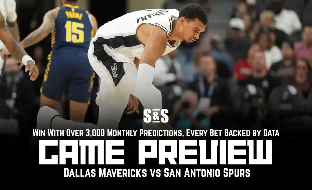 An NBA player crouches on the court during a game preview for the Dallas Mavericks vs. San Antonio Spurs matchup.